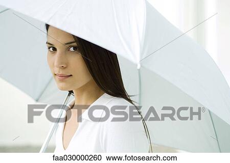 Woman under umbrella, looking at camera View Large Photo Image Stock Image - Woman under umbrella, looking at camera. Fotosearch