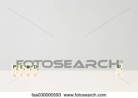 Stock Image - Word game tiles spelling "perd" and "u". Fotosearch
