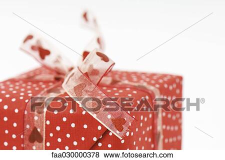 Stock Photo - Wrapped gift, close-up. Fotosearch