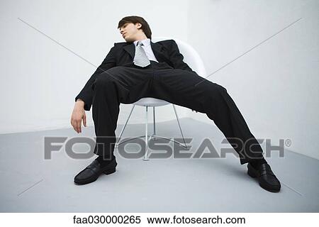 Young businessman slouching in chair, eyes closed View Large Photo Image Stock Photography - Young businessman slouching in chair, eyes closed. Fotosearch