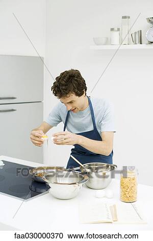 Young man cooking at stove View Large Photo Image Stock Image - Young man cooking at stove. Fotosearch