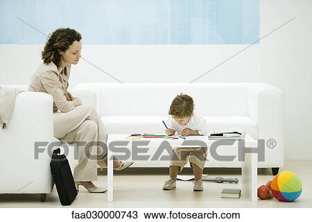 Young professional woman with briefcase sitting in waiting room while son colors View Large Photo Image Stock Image - Young professional woman with briefcase sitting in waiting room while son colors. Fotosearch