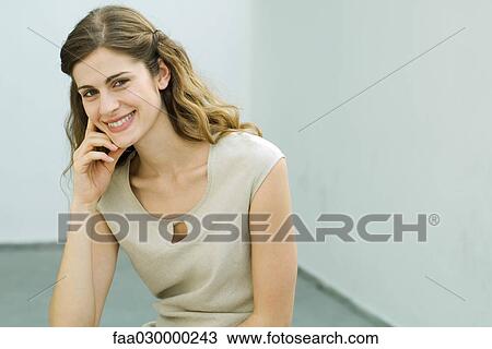 Young woman smiling at camera, portrait View Large Photo Image Stock Image - Young woman smiling at camera, portrait. Fotosearch