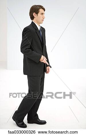 Businessman walking with white cane, side view View Large Photo Image Stock Photograph - Businessman walking with white cane, side view. Fotosearch