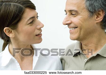 Couple smiling at each other, close-up View Large Photo Image Stock Photography - Couple smiling at each other, close-up. Fotosearch