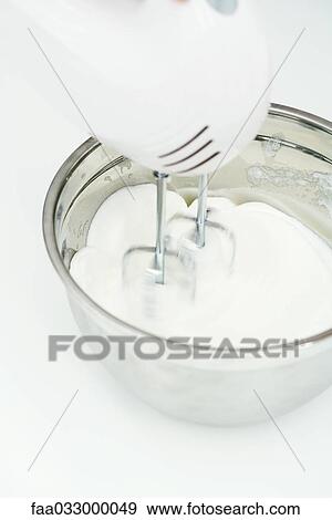 Electric mixer and bowl of batter, close-up, high angle view View Large Photo Image Stock Photo - Electric mixer and bowl of batter, close-up, high angle view. Fotosearch