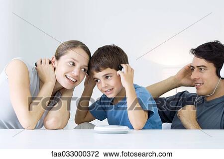 Family listening to CD player together, mother and son sharing headphones View Large Photo Image Stock Image - Family listening to CD player together, mother and son sharing headphones. Fotosearch