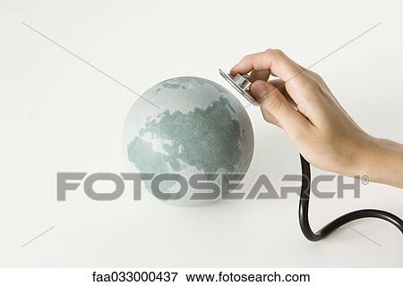 Hand holding stethoscope up to globe, cropped View Large Photo Image Stock Photo - Hand holding stethoscope up to globe, cropped. Fotosearch