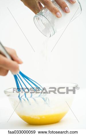 Hand holding whisk, pouring flour into mixing bowl View Large Photo Image Stock Photo - Hand holding whisk, pouring flour into mixing bowl. Fotosearch