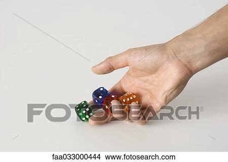 Hand rolling dice View Large Photo Image Picture - Hand rolling dice. Fotosearch