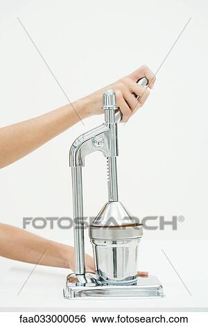 Hand using chrome juicer, cropped view View Large Photo Image Stock Photograph - Hand using chrome juicer, cropped view. Fotosearch