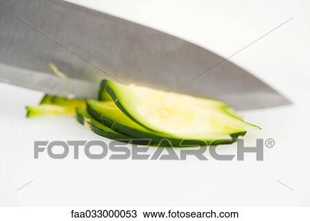 Knife slicing summer squash (zapallito redondo), extreme close-up View Large Photo Image Stock Image - Knife slicing summer squash (zapallito redondo), extreme close-up. Fotosearch