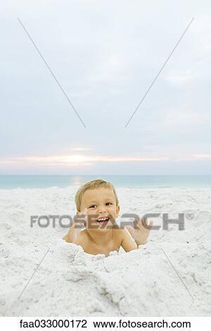 Little boy at the beach, smiling at camera, portrait View Large Photo Image Stock Image - Little boy at the beach, smiling at camera, portrait. Fotosearch