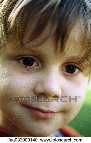 Stock Image - Little boy smiling at camera, headshot, portrait. Fotosearch