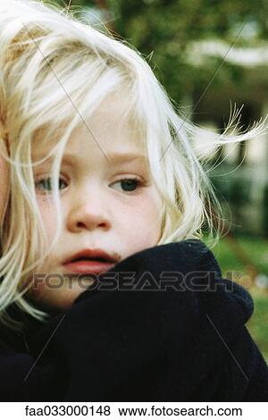 Stock Photo - Little girl looking away, frowning, portrait. Fotosearch