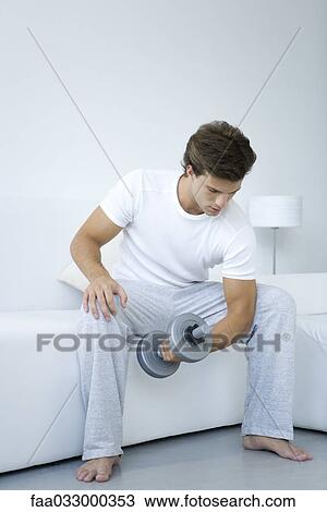 Man lifting dumbbell, full length View Large Photo Image Stock Image - Man lifting dumbbell, full length. Fotosearch