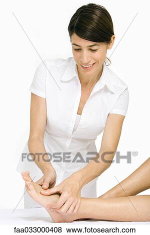 Massage therapist performing foot massage View Large Photo Image Stock Photo - Massage therapist performing foot massage. Fotosearch