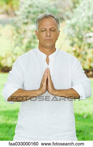 Mature man in prayer position outdoors, eyes closed View Large Photo Image Stock Image - Mature man in prayer position outdoors, eyes closed. Fotosearch