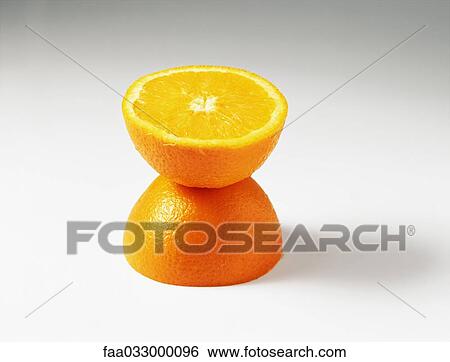 Orange halves, one stacked on top of the other View Large Photo Image Stock Photograph - Orange halves, one stacked on top of the other. Fotosearch
