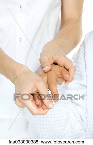 Stock Photography - Person receiving hand massage, cropped view. Fotosearch