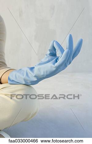 Person wearing rubber glove, sitting in lotus position, cropped view of hand View Large Photo Image Stock Photograph - Person wearing rubber glove, sitting in lotus position, cropped view of hand. Fotosearch