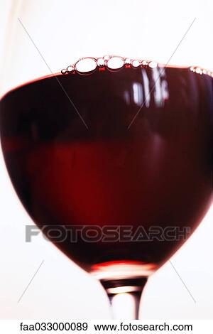 Stock Photo - Red wine in glass, close-up. Fotosearch