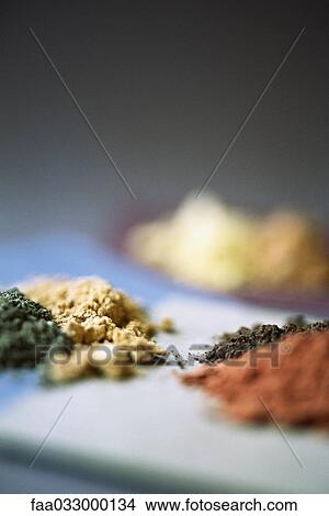 Picture - Several piles of different colored powders, selective focus, close-up. Fotosearch
