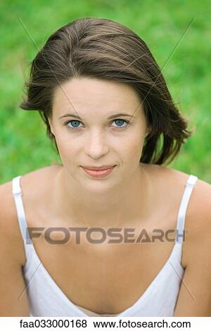 Teenage girl looking at camera, hair tousled by wind, portrait View Large Photo Image Stock Photo - Teenage girl looking at camera, hair tousled by wind, portrait. Fotosearch
