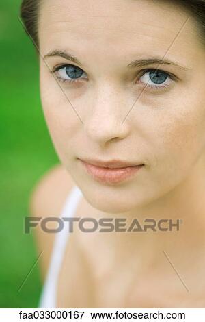 Stock Photo - Teenage girl smiling at camera, portrait. Fotosearch