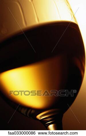 Stock Photograph - White wine in glass, extreme close-up. Fotosearch