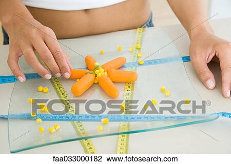 Woman arranging raw vegetables and measuring tapes, cropped view View Large Photo Image Stock Image - Woman arranging raw vegetables and measuring tapes, cropped view. Fotosearch