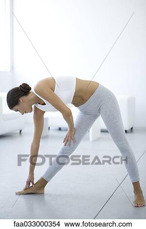 Woman bending over, touching toes View Large Photo Image Picture - Woman bending over, touching toes. Fotosearch