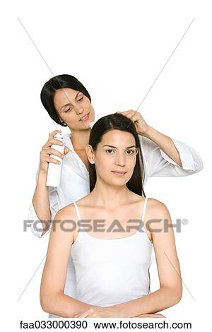 Woman having her hair styled, smiling at camera View Large Photo Image Stock Image - Woman having her hair styled, smiling at camera. Fotosearch