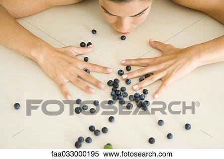 Woman leaning over scattered blueberries, cropped view View Large Photo Image Stock Photography - Woman leaning over scattered blueberries, cropped view. Fotosearch