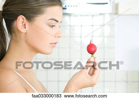 Woman looking at radish, side view View Large Photo Image Stock Image - Woman looking at radish, side view. Fotosearch