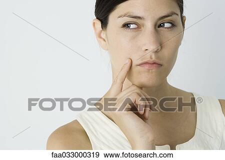 Woman looking away, hand under chin View Large Photo Image Stock Photo - Woman looking away, hand under chin. Fotosearch