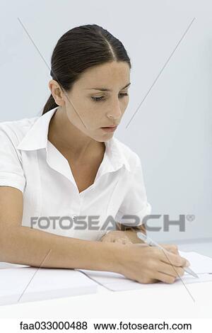 Woman reading document, holding pen View Large Photo Image Stock Photo - Woman reading document, holding pen. Fotosearch
