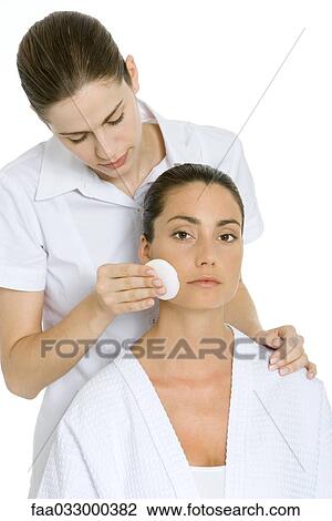 Woman receiving facial, looking at camera View Large Photo Image Stock Image - Woman receiving facial, looking at camera. Fotosearch