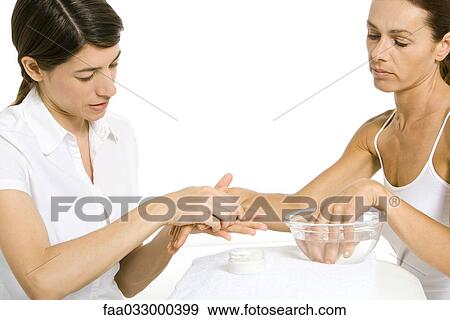 Stock Photo - Woman receiving hand massage. Fotosearch