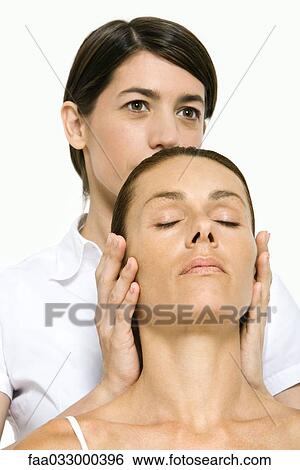 Stock Photograph - Woman receiving head massage, eyes closed. Fotosearch