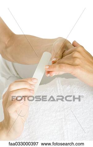 Woman receiving manicure, cropped view of hands View Large Photo Image Stock Photo - Woman receiving manicure, cropped view of hands. Fotosearch