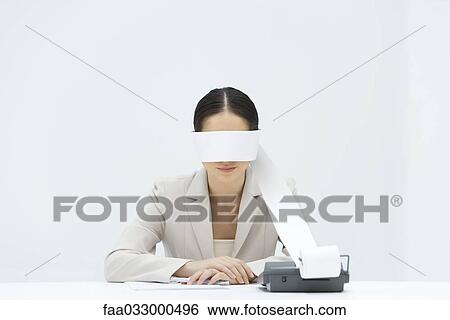 Woman sitting at desk, tape from an adding machine wrapped around her eyes, arms folded View Large Photo Image Stock Photograph - Woman sitting at desk, tape from an adding machine wrapped around her eyes, arms folded. Fotosearch
