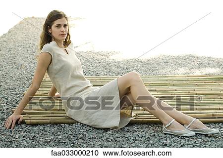 Woman sitting on bamboo mat, smiling at camera, full length View Large Photo Image Stock Image - Woman sitting on bamboo mat, smiling at camera, full length. Fotosearch