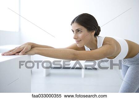 Woman stretching, bending over, arms outstretched View Large Photo Image Stock Photography - Woman stretching, bending over, arms outstretched. Fotosearch