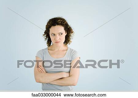 Woman sulking, arms folded, portrait View Large Photo Image Picture - Woman sulking, arms folded, portrait. Fotosearch