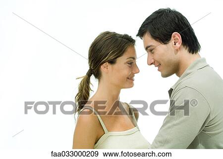 Young couple face to face, smiling at each other, portrait View Large Photo Image Stock Photo - Young couple face to face, smiling at each other, portrait. Fotosearch