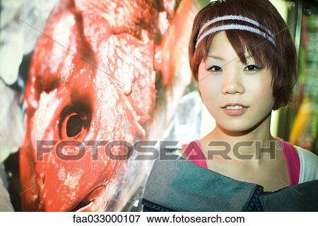 Young Japanese woman smiling at camera, portrait View Large Photo Image Stock Photo - Young Japanese woman smiling at camera, portrait. Fotosearch