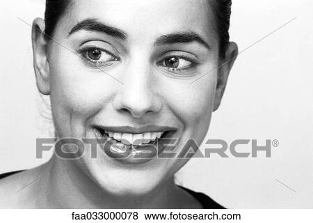 Stock Photo - Young woman smiling, portrait. Fotosearch