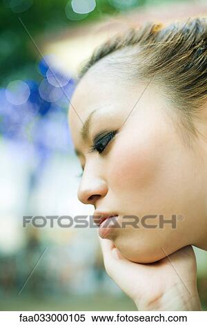 Young woman with hand under chin, profile View Large Photo Image Stock Photography - Young woman with hand under chin, profile. Fotosearch