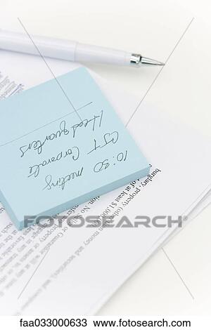 Adhesive note on top of document, pen nearby View Large Photo Image Stock Image - Adhesive note on top of document, pen nearby. Fotosearch